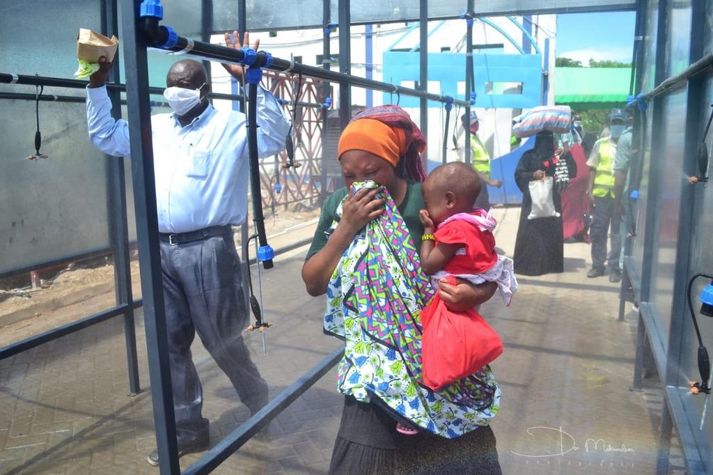 Ferry users in Mombasa being disinfected before being allowed to board the Likoni ferry. Courtesy: Mombasa County