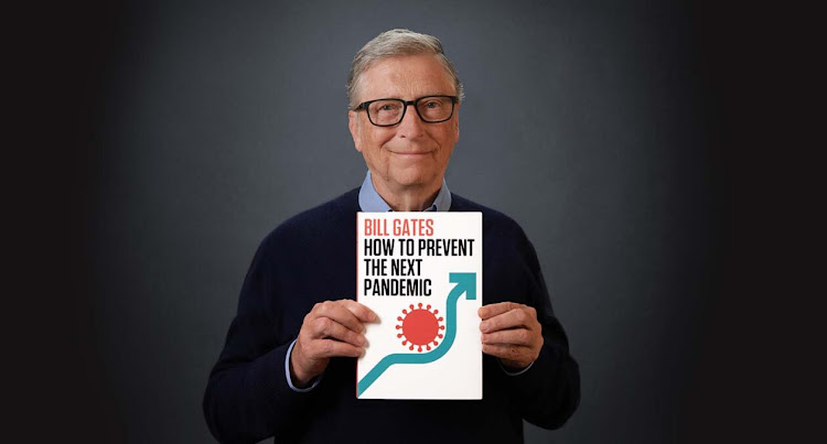 Bill Gates holding his new book, How to Prevent the Next Pandemic